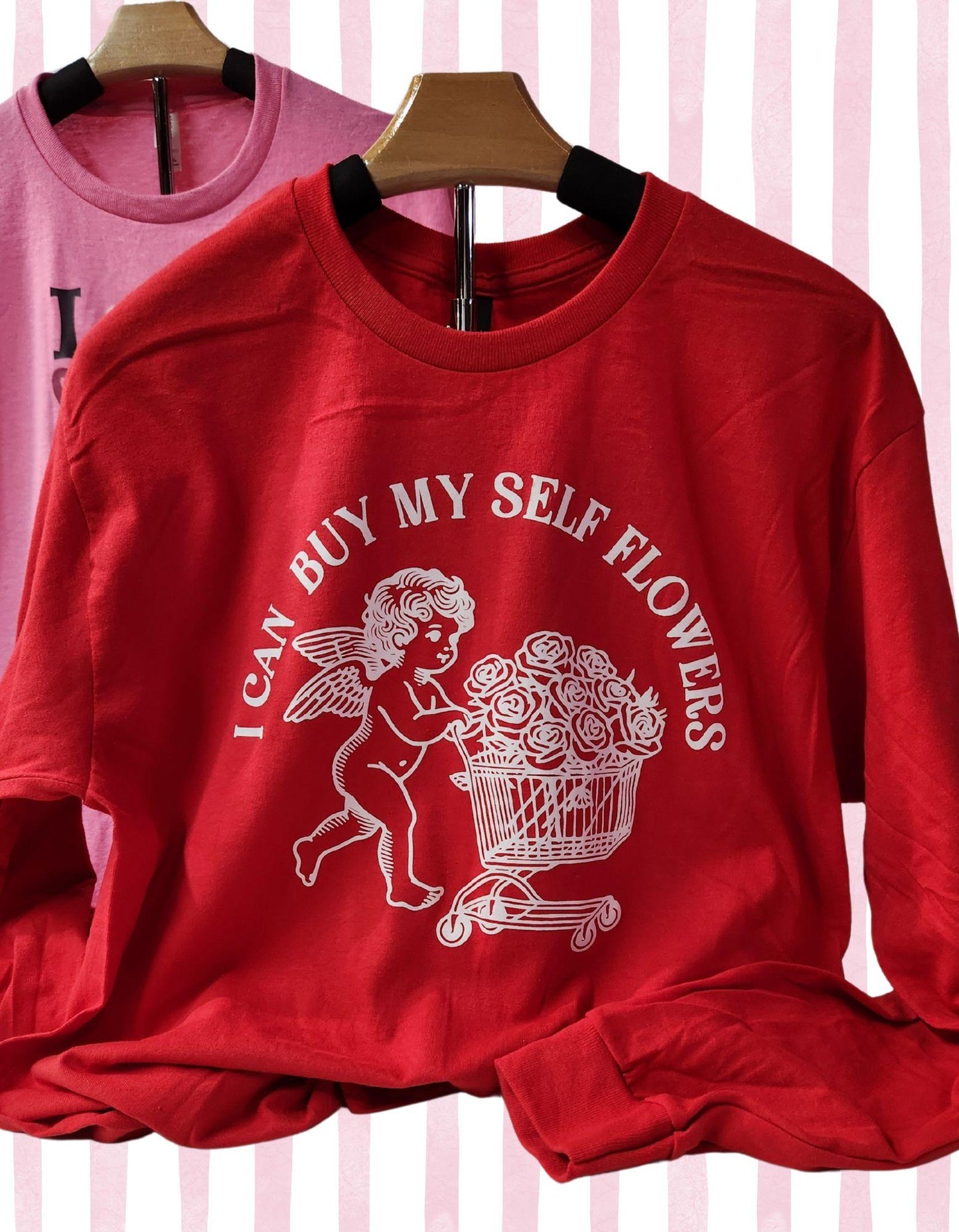 Red sweatshirt with a graphic design and text on a striped background