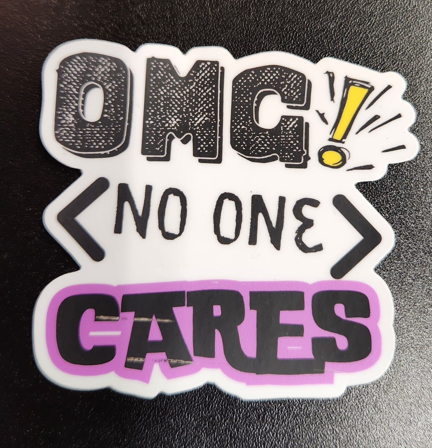 Sticker with text 'OMG! No one cares' on a black background