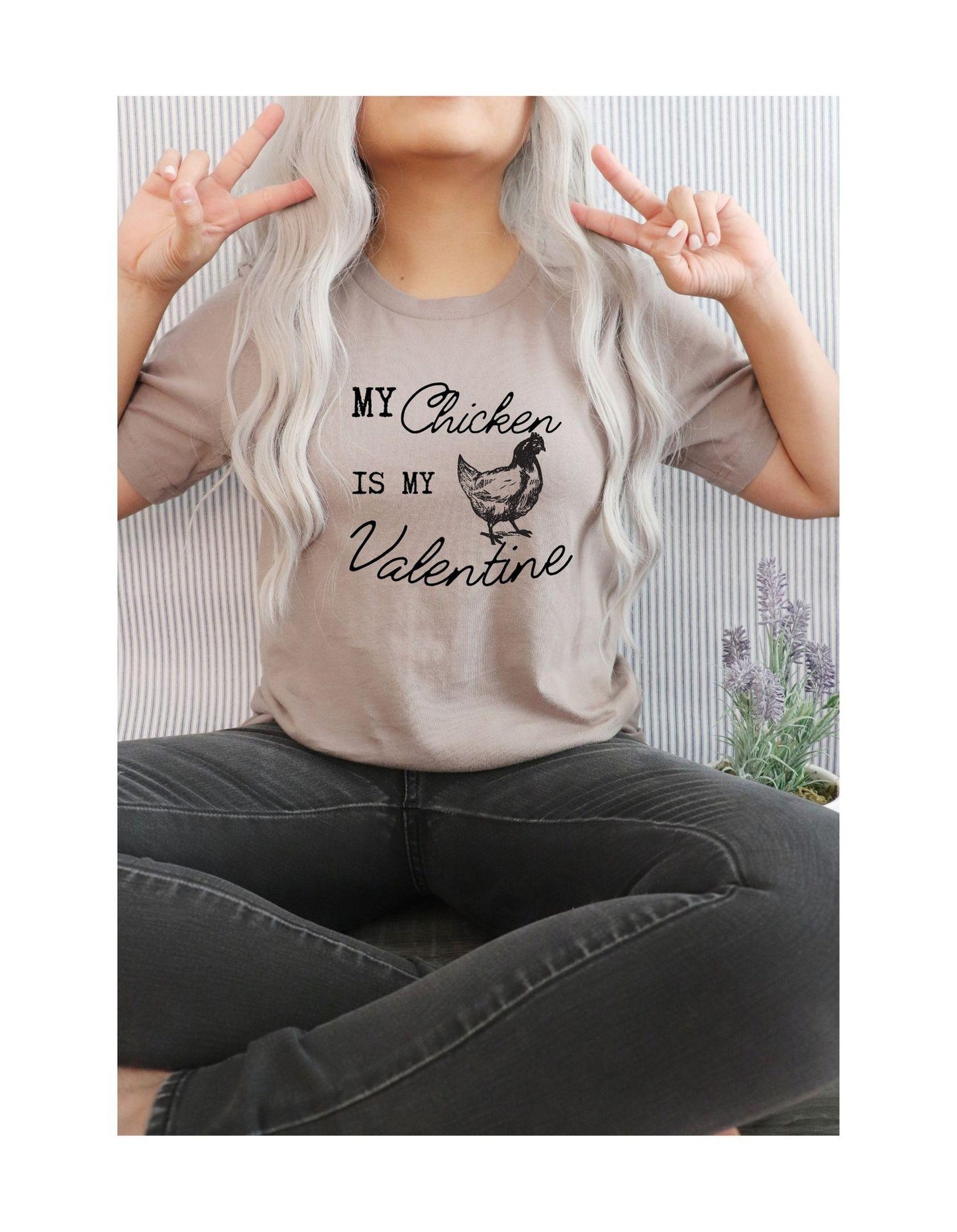 Person wearing a t-shirt with 'My Chicken is My Valentine' text and graphic.
