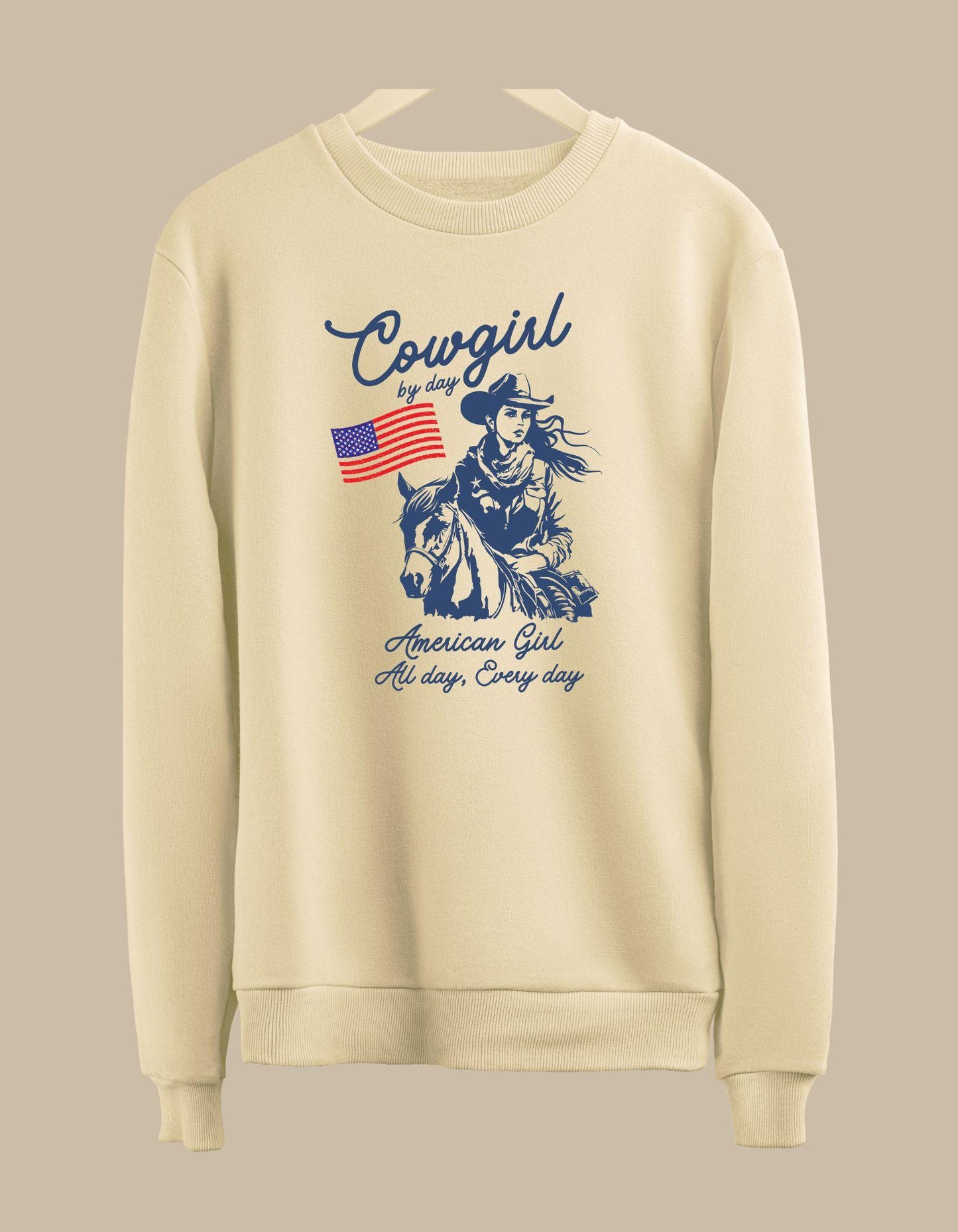 Beige sweatshirt with a graphic of a cowgirl and text