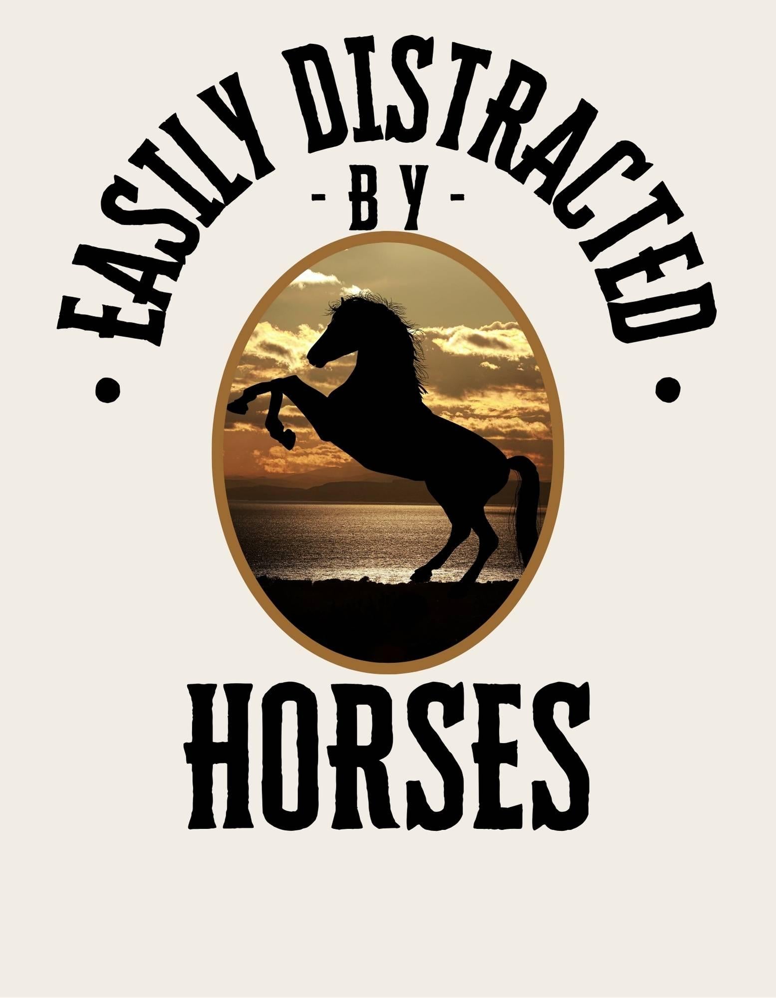 Silhouette of a horse rearing on a beach with 'Easily Distracted by Horses' text.