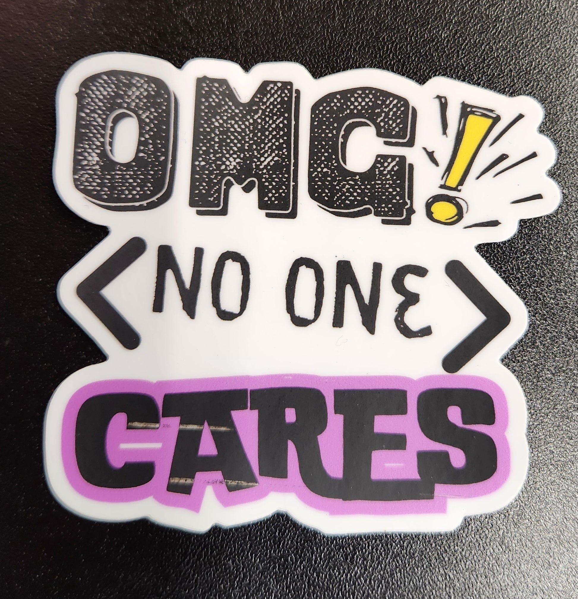 Sticker with text 'OMG! No one cares' on a black background