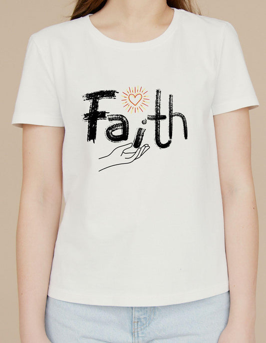 Person wearing a white t-shirt with 'Faith' and a hand graphic on a beige background