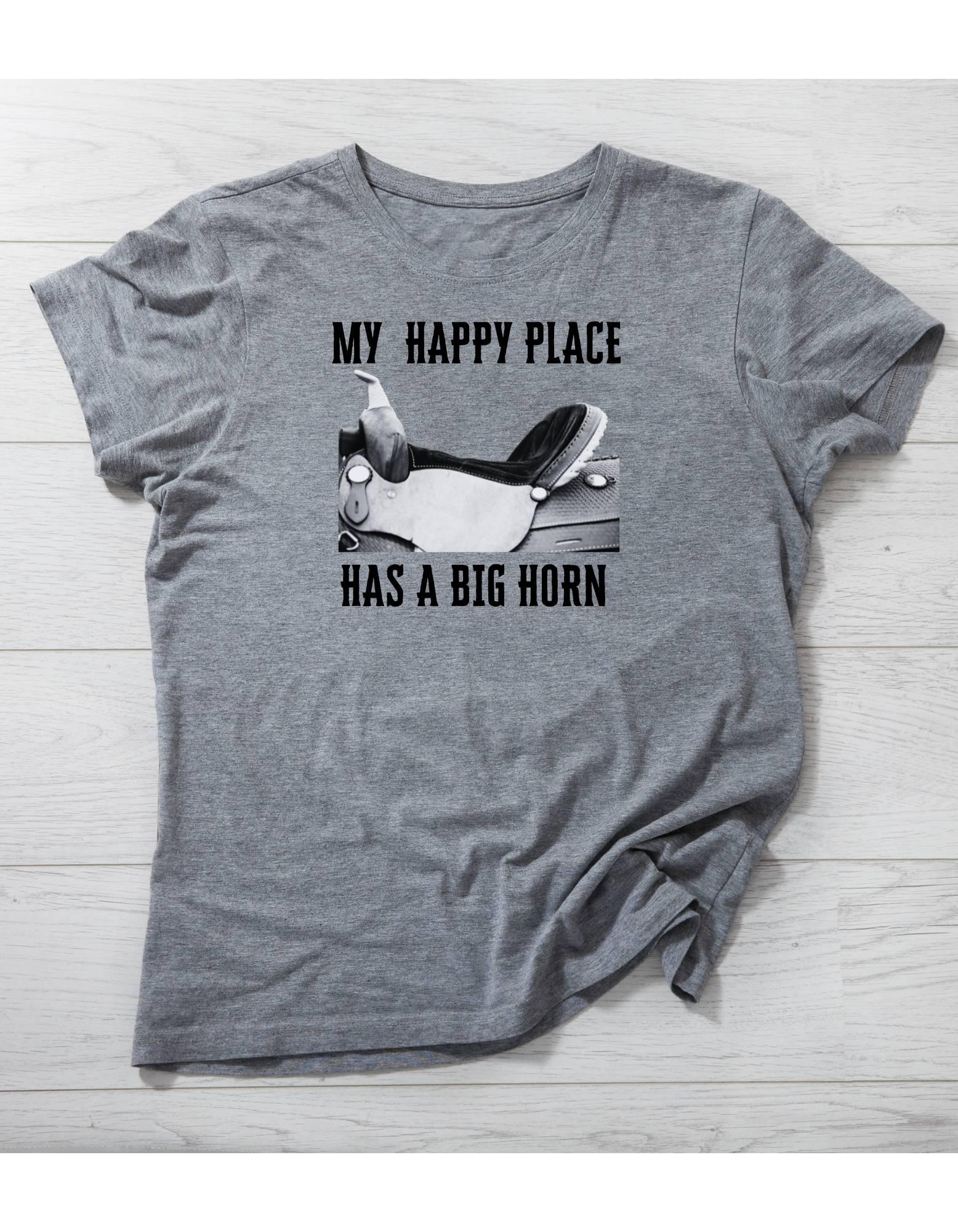 Gray t-shirt with graphic and text 'My happy place has a big horn' on a wooden surface