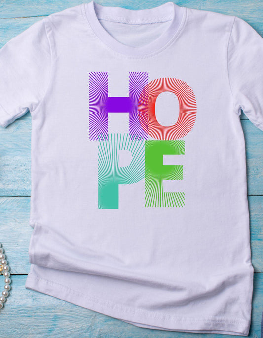 White t-shirt with 'HOPE' in colorful letters on a blue wooden surface