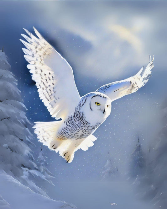 Snowy owl flying in a snowy landscape with a blurred background