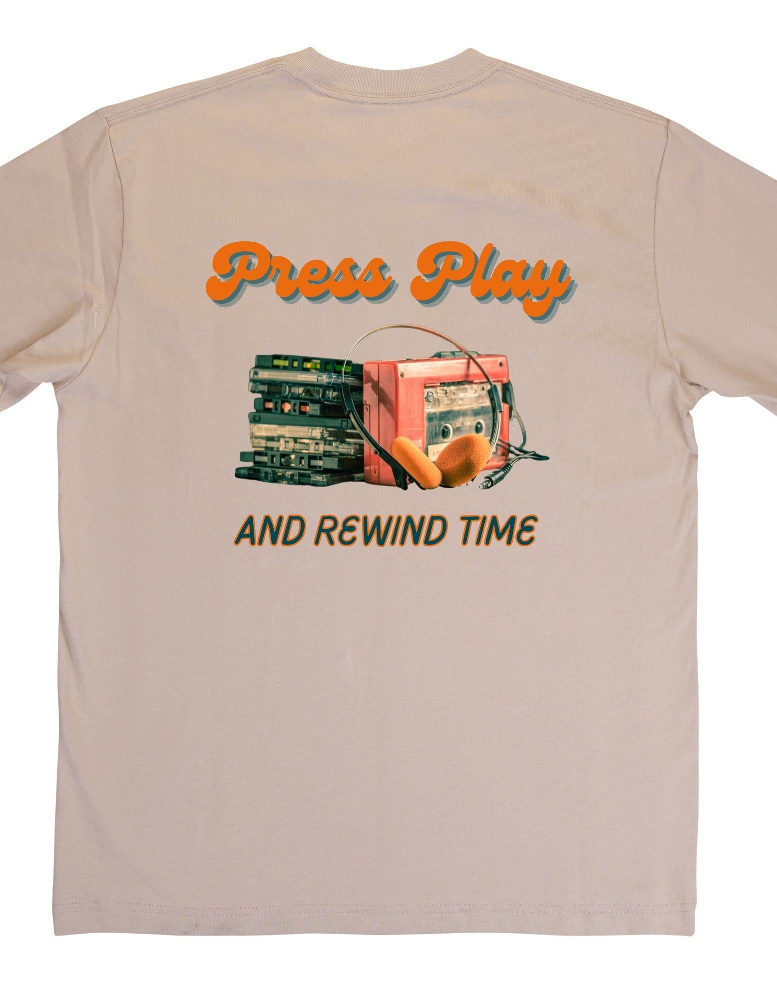 Beige t-shirt with vintage record player graphic and text 'Press Play and Rewind Time' on a beige background