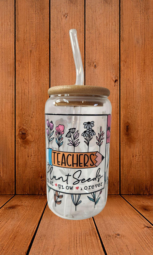 Glass tumbler with straw and decorative label on a wooden background