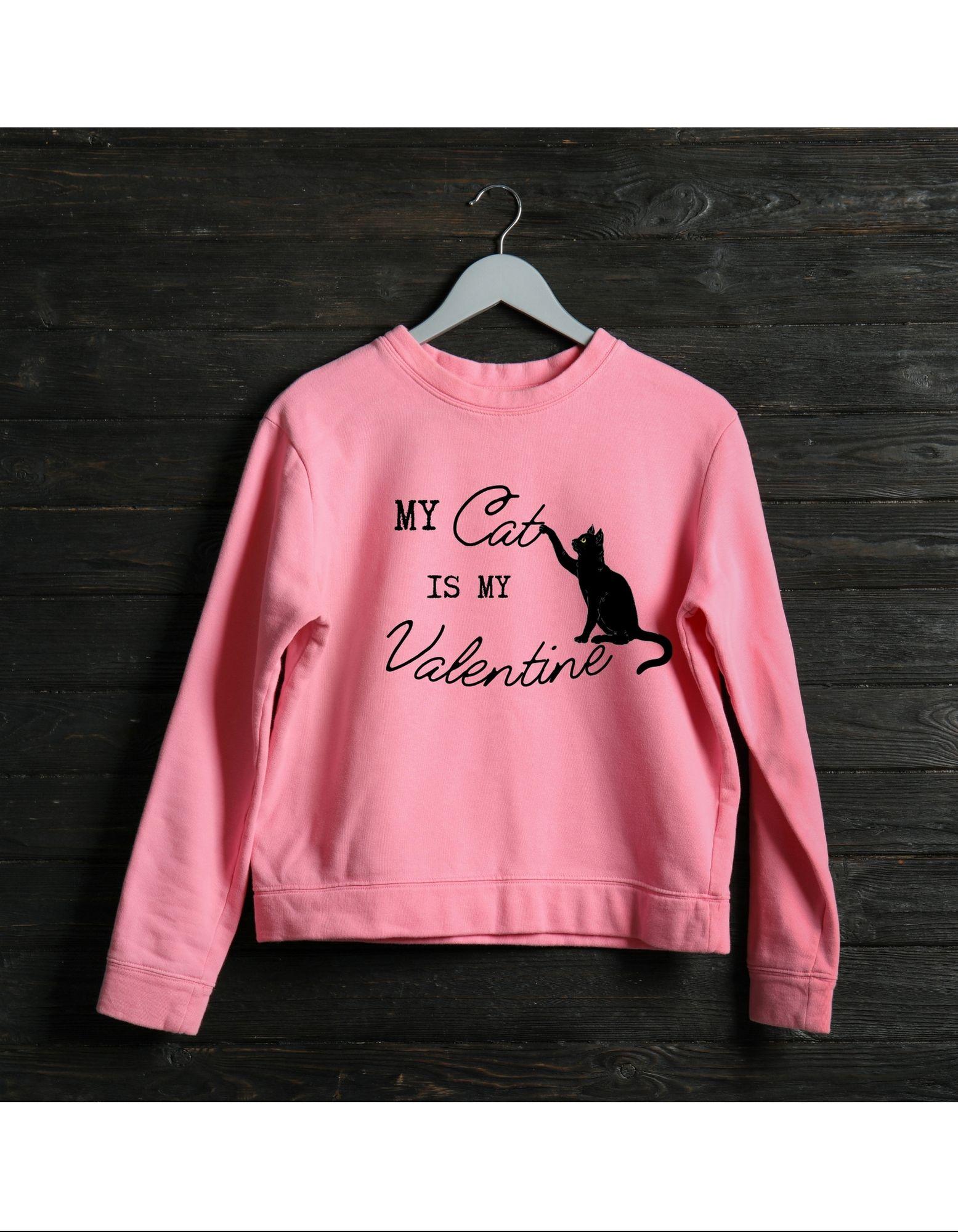 Pink sweatshirt with 'My Cat is My Valentine' text on a wooden background