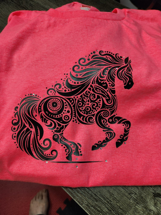 A bright pink shirt with a black vinyl horse mandala design on it.